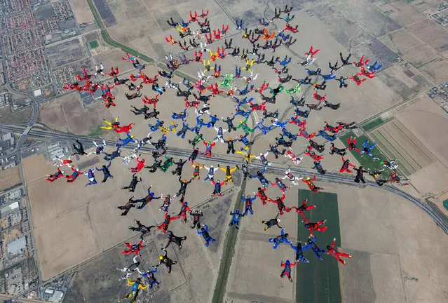 This Tuesday, September 29, 2015 photo provided by Craig O'Brien shows a record-breaking skydiving formation above Perris, Calif. Two-hundred-and-two skydivers from around the world set the record when they all linked up thousands of feet above Southern California. The group formed the largest sequential skydiving formation. (Photo by Craig O'Brien/AP Photo)