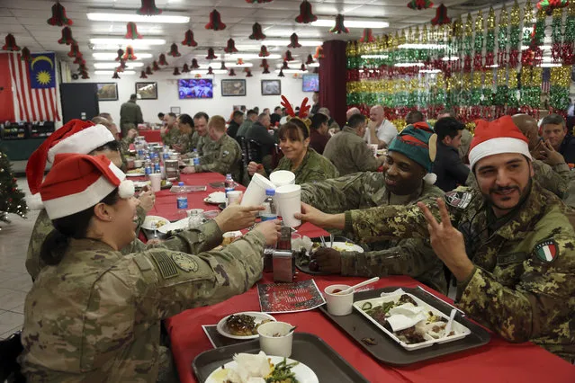 Members of the U.S. military eat Christmas dinner at the Resolute Support Headquarters in Kabul, Afghanistan, Monday, December 25, 2017. (Photo by Rahmat Gul/AP Photo)