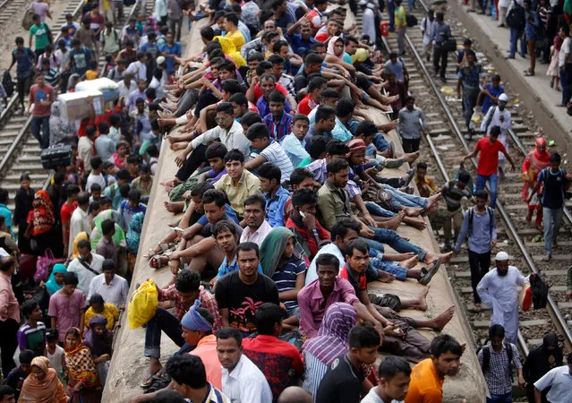 People sit atop an overcrowded passenger train as they travel home to celebrate the Eid al-Adha festival, at a railway station in Dhaka, Bangladesh, September 9, 2016. (Photo by Mohammad Ponir Hossain/Reuters)