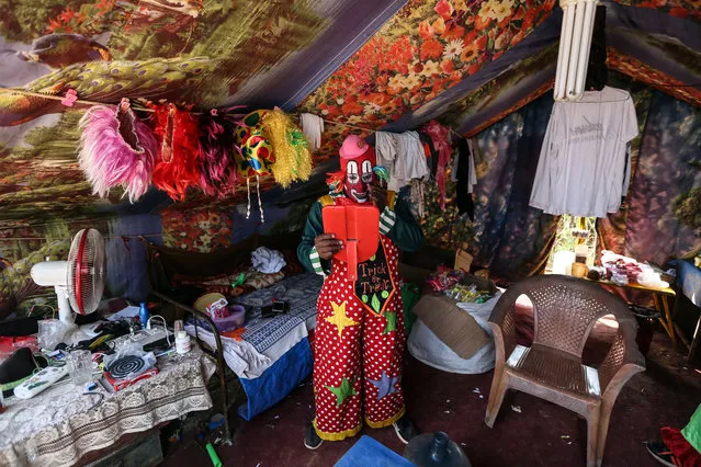 Artist Biju Nair gets ready for his performance in his tent behind the main show area at Rambo Circus in Mumbai, India, 04 November 2017. Biju Nair, 47, from Trivendrampuram, Kerala, joined the circus at a very early age. He literally ran away from home and ended up in Mumbai. Biju Nair wandered into a circus and found a job as ticket taker. He did all sort of jobs in the circus as ticket taker, bouncer, announcer and clown. Biju Nair was always fascinated by clown acts. He always tries to improve himself with new acts and learns from international clowns by watching online videos. He is in the circus industry for 38 years and since he was 18 he is performing as clown. Biju Nair had so many ups and down in his life but always enjoys making people laugh. He has two children who live in Kerala where they get education in school which he did not get. (Photo by Divyakant Solanki/EPA/EFE)