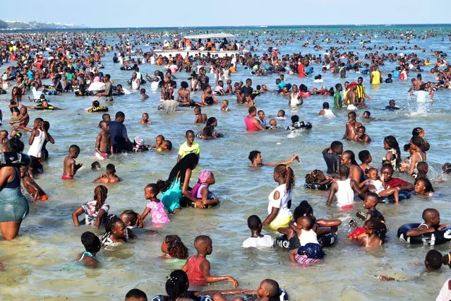 Hundreds of holiday makers enjoy themselves at the open Jomo Kenyatta Public Beach on Christmas day after attending church services in various churches in Mombasa town, Kenya, Sunday, December 25, 2022. (Photo by Gideon Maundu/AP Photo)