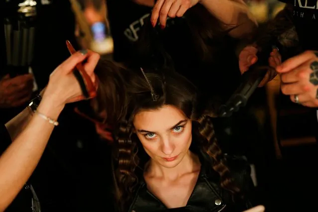 Hairdressers brush a model´s hair during the 080 Barcelona Fashion Week in Barcelona on January 31, 2018. (Photo by Pau Barrena/AFP Photo)