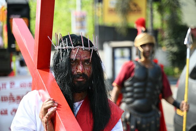 Christian devotees participate in the re-enactment of the crucifixion of Jesus Christ during a procession on Good Friday in Chennai India on March 29, 2024. (Photo by R.Satish Babu/AFP Photo)