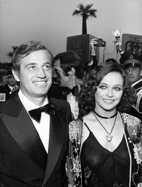 In this June 16, 1974 file photo, French actor Jean-Paul Belmondo and actress Laura Antonelli of Italy arrive at Festival House for presentation of film “Stavisky”, on June 16, 1974. French New Wave actor Jean-Paul Belmondo has died, according to his lawyer’s office on Monday Sept. 6, 2021. (Photo by Levy/AP Photo/File)