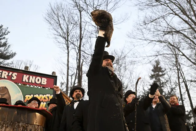 Groundhog Club handler A.J. Dereume holds Punxsutawney Phil, the weather prognosticating groundhog, during the 137th celebration of Groundhog Day on Gobbler's Knob in Punxsutawney, Pa., Thursday, February 2, 2023. Phil's handlers said that the groundhog has forecast six more weeks of winter. (Photo by Barry Reeger/AP Photo)