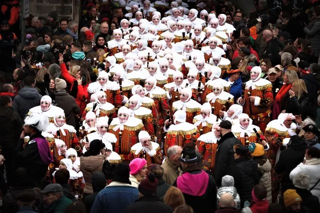 Festival participants known as “Gilles”, wearing traditional costumes, during Carnival celebrations in the streets of Binche, Belgium, 21 February 2023. The Carnival de Binche is a popular historical cultural event that was named a Masterpiece of the Oral and Intangible Heritage of Humanity by UNESCO in 2003. (Photo by Stephanie Lecocq/EPA)
