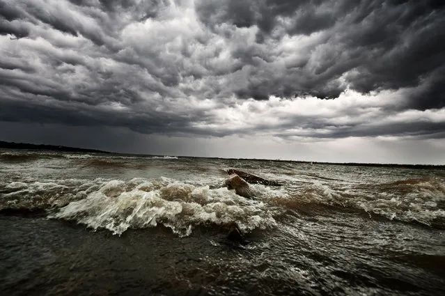 The waves and clouds reflect each other at Lake Lewisville, Lewisville, Texas on March 2013. (Photo by Mike Mezeul II/Caters News)