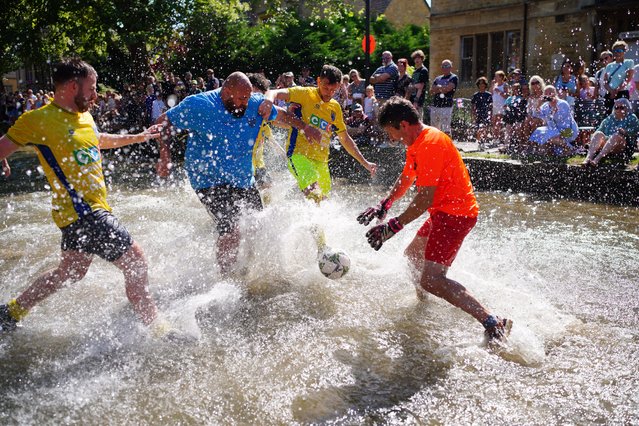 Footballers from Bourton Rovers create a splash as they fight for the ball on Monday, August 25, 2025 during the annual traditional River Windrush football match, which has been taking place for over 100 years, in the Cotswolds village of Bourton-in-the-Water, Gloucestershire, UK. (Photo by Ben Birchall/PA Images via Getty Images)