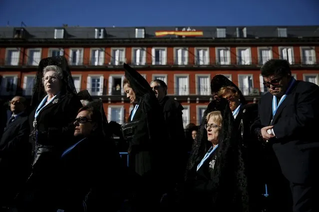 Women wearing traditional "mantilla" dresses take part in an open-air mass to celebrate Madrid's patron saint La Almudena Virgin in Madrid, Spain, November 9, 2015. (Photo by Susana Vera/Reuters)