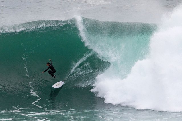A surfer rides a wave at Deadman's off Fairy Bower headland at Manly Beach on April 02, 2025 in Sydney, Australia. The large swell has been generated by a strong low pressure system moving down the East Coast of Australia. (Photo by Cameron Spencer/Getty Images)