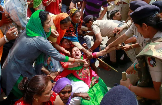 Police detain villagers blocking the demolition of illegal houses by local authorities at Khuda Ali Sher village in Chandigarh, India, April 27, 2018. (Photo by Ajay Verma/Reuters)