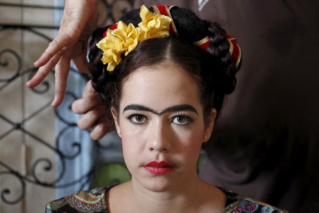 Andrea Doimeadios, representing Mexican painter Frida Kahlo gets ready to perform in a school of theatre, makeup and hair styling graduation contest in Havana, November 16, 2015. (Photo by Reuters/Stringer)