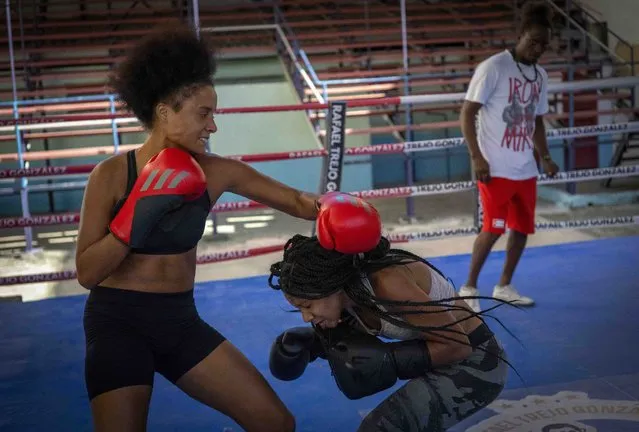 Boxer Giselle Bello Garcia, left, throws a punch at Ydamelys Moreno during a training session in Havana, Cuba, Monday, December 5, 2022. Cuban officials announced on Monday that women boxers would be able to compete for the first time ever. (Photo by Ramon Espinosa/AP Photo)
