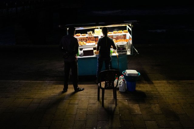 A street food vendor sells food to customers in Colombo, Sri Lanka, on September 17, 2025. (Photo by Thilina Kaluthotage/NurPhoto/Rex Features/Shutterstock)