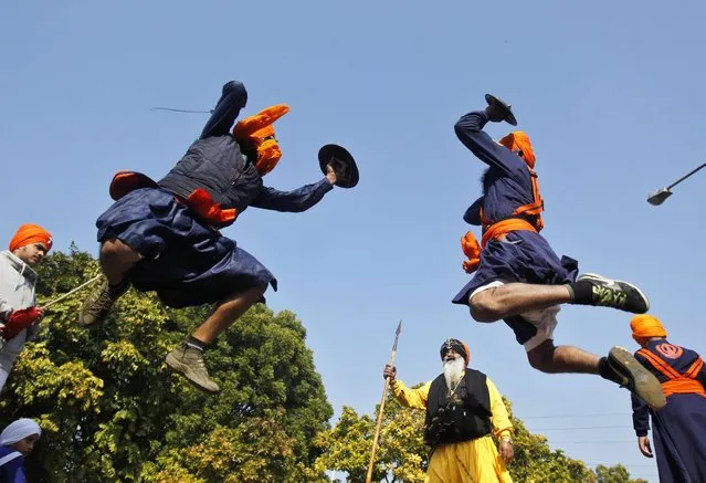 Nihangs or Sikh warriors perform “Gatkha”, a traditional form of martial arts, during a religious procession ahead of the birth anniversary of Guru Gobind Singh in the northern Indian city of Chandigarh January 5, 2015. (Photo by Ajay Verma/Reuters)