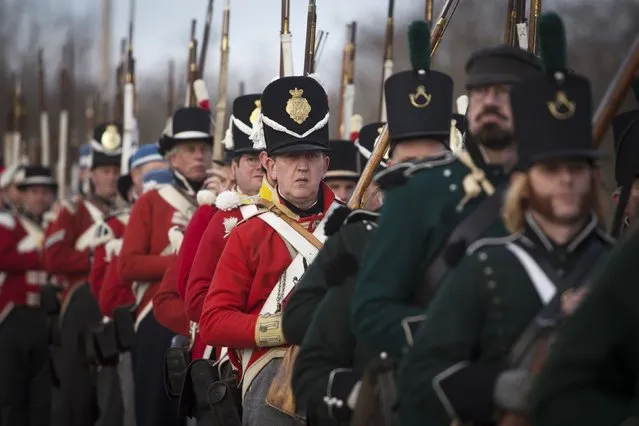 Reenactors playing the roll of British soldiers march during a reenactment of the Battle of New Orleans in the War of 1812, marking its bicentennial  in Chalmette, Louisiana January 10, 2015. (Photo by Lee Celano/Reuters)
