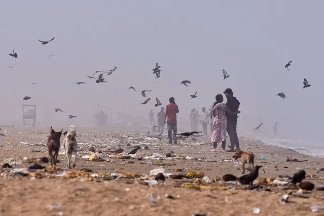 Beachgoers stroll amidst the haze influenced by the cyclone Mocha, during a hot afternoon, at Marina beach, in Chennai, India, 15 May 2023. According to the Regional Meteorological Centre (RMC) data, Chennai recorded a maximum daytime temperature of 40.7 degrees Celcius on 14 May 2023, making it the hottest day of the year so far. The temperature rise was influenced due to the cyclonic storm Mocha, resulting in heat warning issued for the next couple of days. (Photo by Idrees Mohammed/EPA/EFE/Rex Features/Shutterstock)