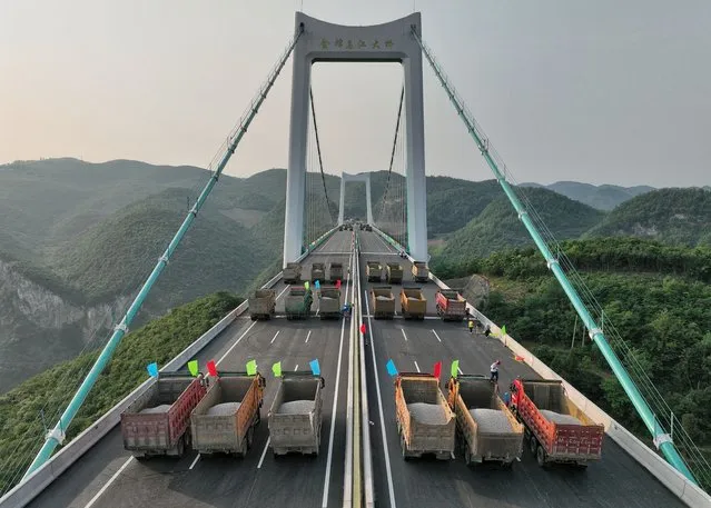 Trucks conduct a load test on the Jinfeng Wujiang River Bridge, a main project on the Guiyang-Jinsha-Gulin (Guiyang and Jinsha of Guizhou Province and Gulin of Sichuan Province) expressway, on May 21, 2023 in Guiyang, Guizhou Province of China. (Photo by Qu Honglun/China News Service/VCG via Getty Images)