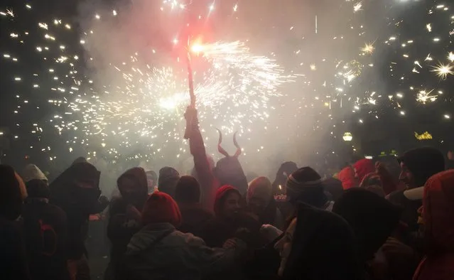 People take part in the traditional festival of “Correfoc” in Palma de Mallorca, on January 17, 2015. (Photo by Jaime Reina/AFP Photo)