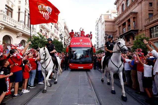 Sevilla players celebrate on the team bus with fans after winning the Europa League in Seville, Spain on June 1, 2023. (Photo by Marcelo Del Pozo/Reuters)