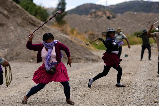 Protesters practice using slings as they block a road in support of former President Evo Morales in the face of an investigation opened against him for the alleged abuse of a minor while in office, in Parotani, Bolivia, Thursday, October 31, 2024. (Photo by Juan Karita/AP Photo)