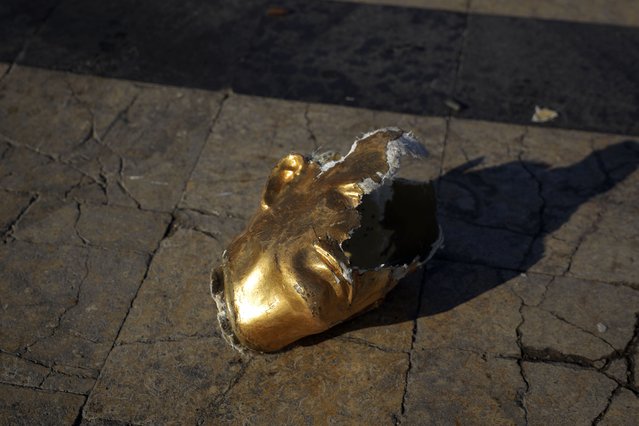 A broken bust of the old Syrian President Hafez Assad, father of the current President Bashar Assad, lies on the ground destroyed by opposition fighters in Aleppo, Syria, November 30, 2024. (Photo by Omar Albam/AP Photo)