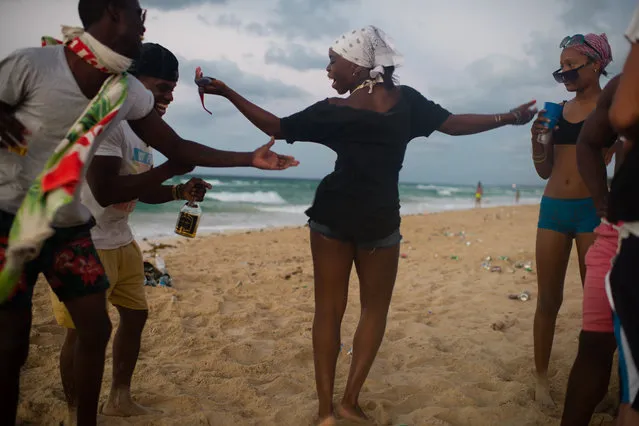 Yanelis Blanco, 24, center, dances with a group of friends at Santa Maria beach, about 15 miles from Havana on April 5, 2015. It is the closest beach to Havana. Others, from left to right are Jackson Miranda, 21, Dayan Suarez, 24, and Melisa Oliva, 15. The men in the group have a rap group together. The government is demolishing buildings all over the coast of East Havana and recovering and restoring beach dunes. (Photo by Sarah L. Voisin/The Washington Post)