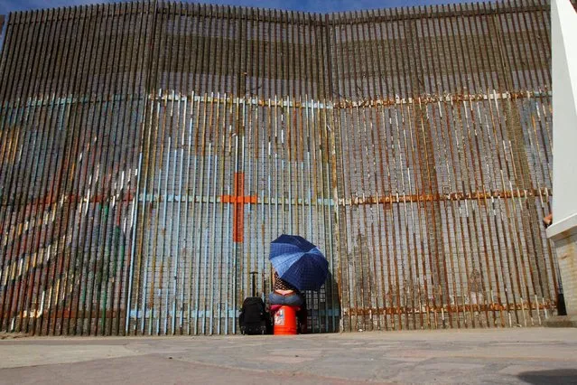 A woman talks to her relatives across a fence separating Mexico and the United States, in Tijuana, Mexico, November 12, 2016. (Photo by Jorge Duenes/Reuters)