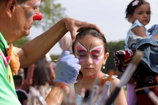 A girl has her face painted as Muslim faithful celebrate the Eid al-Adha festival, in New York City, New York, U.S., June 28, 2023. (Photo by Amr Alfiky/Reuters)