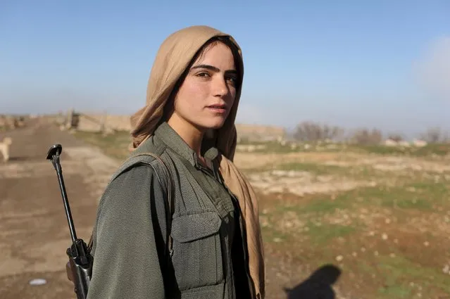 A female Kurdistan Workers Party (PKK) fighter stands near a security position in Sinjar, Iraq March 13, 2015. (Photo by Asmaa Waguih/Reuters)