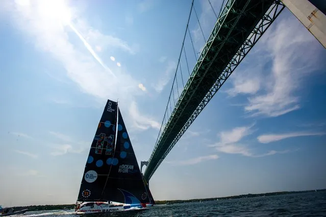 11th Hour Racing Team sails under the Newport Bridge during the in-port race and 5th leg of The Ocean Race in Newport, Rhode Island, on May 21, 2023. The Ocean Race, started in 1973, is an around the world race with seven legs and eight stopover port cities. From Newport the boats will set off on leg 5 of the race, en route to Europe, in a 3,500 nautical mile transatlantic race to Aarhus, Denmark. (Photo by Joseph Prezioso/AFP Photo)