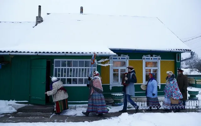 People celebrate the pagan rite called "Kolyadki" in the village of Skirmantava, Belarus, January 7, 2016. (Photo by Vasily Fedosenko/Reuters)