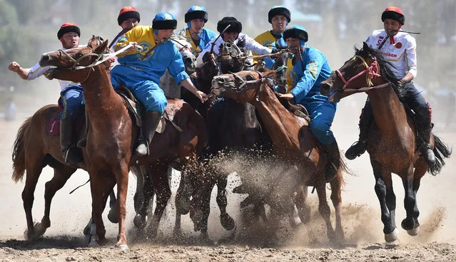 Russian (white) and Kazakh (blue) riders play the traditional Central Asian sport Buzkashi also known as Kok-Boru or Oglak Tartis during the World Nomad Games 2018 in Cholpon-Ata, eastern Kirghizstan, on September 5, 2018. Ex-Soviet Kyrgyzstan kicked off the “World Nomad Games” on September 3, 2018 which it has hosted biennally since 2014 with Turkey pledging to host the 2020 edition of the week-long traditional sport extravaganza. (Photo by Vyacheslav Oseledko/AFP Photo)