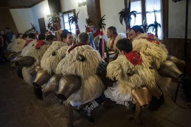 In this photo taken on Tuesday, January 27, 2015 Joaldunaks, also called “Zanpantzar”, eat in a restaurant on their way to take part on the Carnival between of the Pyrenees villages of Ituren and Zubieta, northern Spain. (Photo by Alvaro Barrientos/AP Photo)