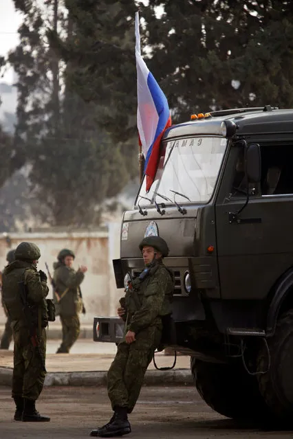 Russian soldiers stand near their vehicles in Aleppo, Syria December 4, 2016. (Photo by Omar Sanadiki/Reuters)