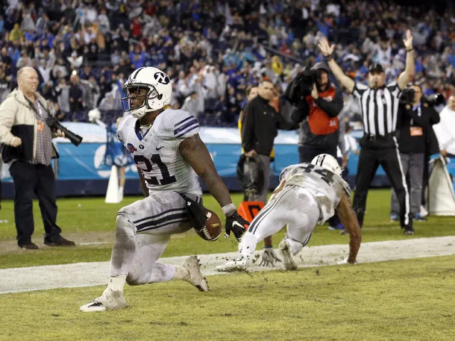 BYU running back Jamaal Williams, left, scores a touchdown against Wyoming during the second half of the Poinsettia Bowl NCAA college football game Wednesday, December 21, 2016, in San Diego. (Photo by Ryan Kang/AP Photo)