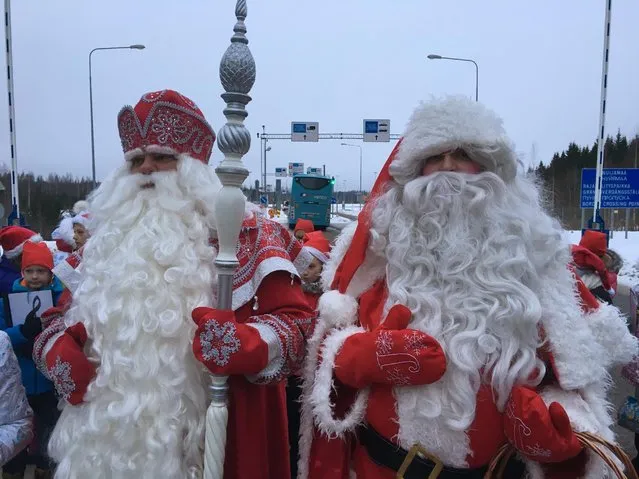 Finland's Santa, right, and Russia's Grandfather Frost meet at the two countries busiest joint border crossing  in Nuijamaa, Finland on Monday December 19, 2016, as an annual show of goodwill and neighborly friendship. But despite the jovial ho-ho-hos in the annual show of seasonal goodwill and neighborly friendship, there lies an increasing disquiet in the Nordic nation. (Photo by Vitnija Saldava/AP Photo)