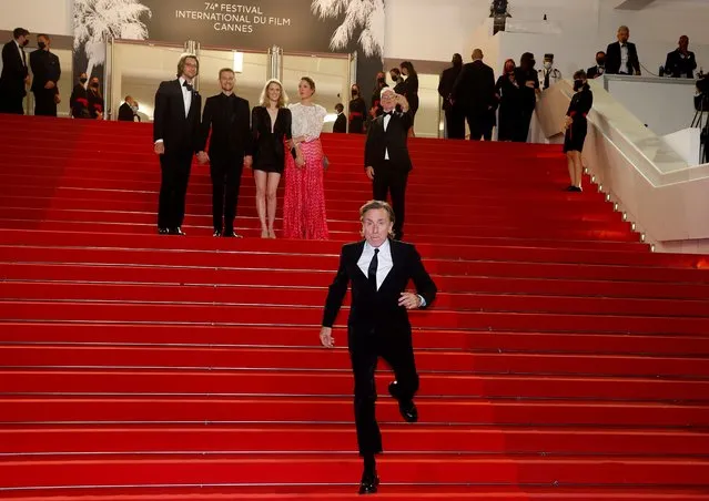 British actor Tim Roth runs on the red carpet as he arrives for the screening of the film “Bergman Island” at the 74th edition of the Cannes Film Festival in Cannes, southern France, on July 11, 2021. (Photo by Eric Gaillard/Reuters)