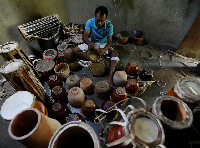 A man works on traditional drums for sale at his workshop in Nittambuwa, Sri Lanka November 8, 2016. (Photo by Dinuka Liyanawatte/Reuters)