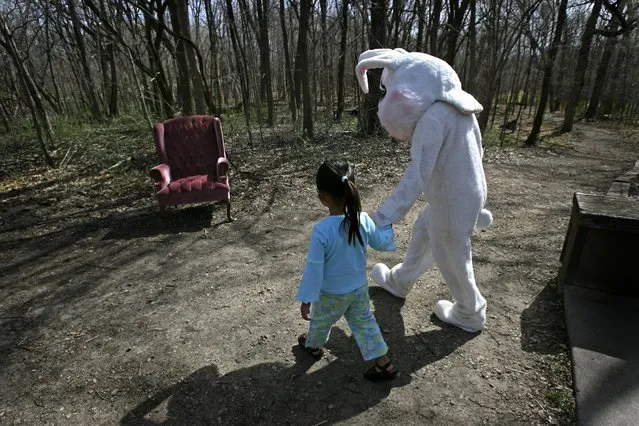 Four-year-old Mya Lillemoen, gives the Easter Bunny a hand to his chair before a small hike at the Eastman Nature Center during the center's Easter activities, Friday, April 14, 2006. Lillemoen was there with her mother Masha Lillemoen of Maple Grove. Children enjoyed a hike, hunting eggs, dying eggs, face painting, arts and crafts, and a visit with real bunnies. (Photo by Elizabeth Flores/Star Tribune)