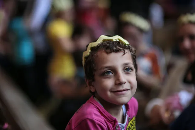 An Egyptian Orthodox Christian boy celebrates Palm Sunday during a service in the Samaan el-Kharaz Church in the Mokattam district of Cairo, Egypt, Sunday, April 5, 2015. (Photo by Mosa'ab Elshamy/AP Photo)