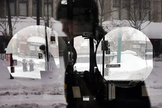 A pedestrian is reflected in the window and mirrors of a hair salon during a winter snow storm in Brookline, Massachusetts February 9, 2015. (Photo by Brian Snyder/Reuters)