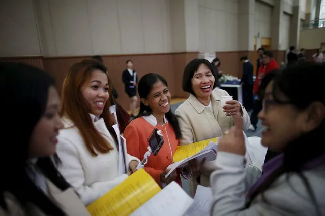 Filipino brides laugh at a joke during an opening ceremony for an upcoming mass wedding ceremony of the Unification Church at Cheongshim Peace World Centre in Gapyeong, South Korea, February 19, 2016. (Photo by Kim Hong-Ji/Reuters)