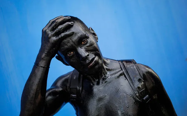 A man with his body covered in motor oil takes part in the celebrations honouring the patron saint of Managua, Santo Domingo de Guzman, in Managua on August 1, 2021. (Photo by Oswaldo Rivas/AFP Photo)