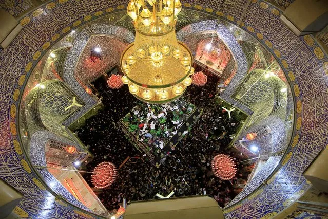 Muslim Shiite faithful visit the shrine of Imam Ali, the son-in-law and cousin of the Prophet Muhammad and the first Imam of the Shiites, on the anniversary of the death of the Prophet Mohammed, in Najaf, Iraq, on January 1, 2013. (Photo by Jaber al-Helo/Associated Press)