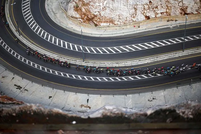 The pack rides during the fourth stage of the Tour of Oman, shortened to 104km between Fanja and Yitti Hills due to weather conditions, on February 13, 2024 in Muscat. (Photo by Anne-Christine Poujoulat/AFP Photo)