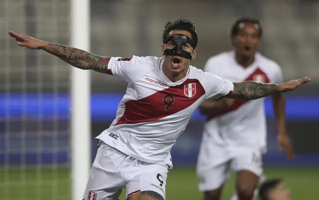 Peru's Gianluca Lapadula celebrates scoring his side's opening goal against Bolivia during a qualifying soccer match for the FIFA World Cup Qatar 2022 at National stadium in Lima, Peru, Thursday, November 11, 2021. (Photo by Sebastian Castaneda/Pool via AP Photo)