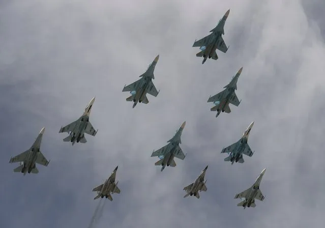 Russian Su-34 bombers, Su-27 fighters and MiG-29 fighters fly in formation above Red Square during the Victory Day parade in Moscow, Russia, May 9, 2015. (Photo by Reuters/Host Photo Agency/RIA Novosti)