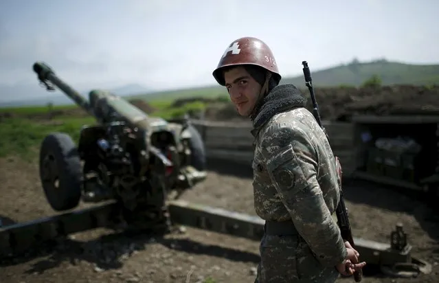 An ethnic Armenian soldier stands next to a cannon at the artillery positions near Nagorno-Karabakh's town of Martuni, April 8, 2016. (Photo by Reuters/Staff)