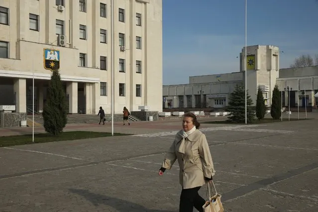 A woman walks past an administrative building, April 8, 2016, in Slavutych, Ukraine. Slavutych is a new town built in the years after the Chernobyl accident to replace Pripyat, the town that had previously housed Chernobyl workers and their families and was abandoned due to radioactive contamination. (Photo by Sean Gallup/Getty Images)